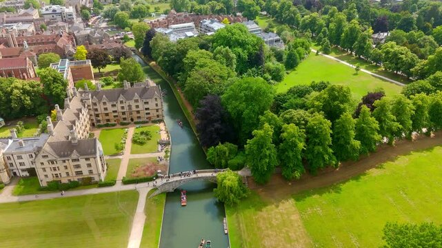 Aerial view of punts on the River Cam with the Cambridge University buildings and park in the background, UK