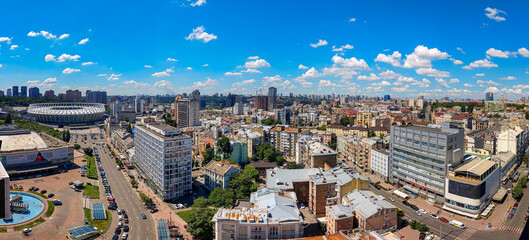Bird's eye view of Kyiv center town Ukraine. Downtown in dense development vision. Farsightedness and clarity. Stadium building, arena, skyscraper, street and cars, Clear horizon with few clouds