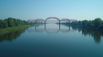Obraz premium Steel bridge spans calm river, mirrored in water