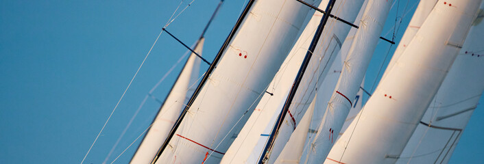 Few sails of sailboats at the sailing regatta in the Gulf of Finland at sunset, hot race of several yachts, nobody