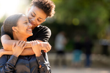young romantic latin or hispanic couple outdoors embracing