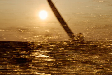 Sailing regatta in the Gulf of Finland at sunset, sailing yacht competing in a race, splashing...