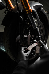 Front Brake Pad Replacement on Red Sport Motorcycle. Front brake pads are inspected and swapped out...