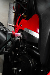 Precision oil fill operation on a red sportbike to ensure proper engine lubrication. Motorcycle Oil...