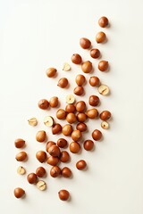 Scattered Shelled Brown Nuts on White Background Food Photography Healthy Snack Organic