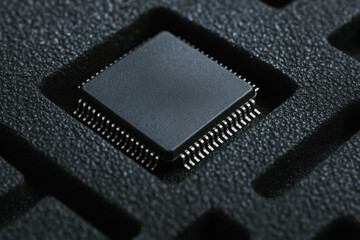 Semiconductor chip in protective packaging highlights precision and care in industry production process for advanced technology components