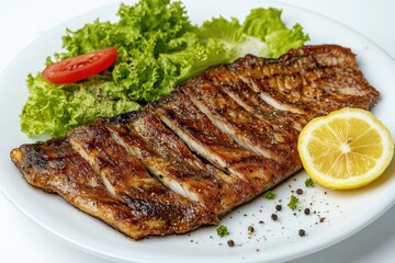 Grilled fish fillet served with salad and lemon