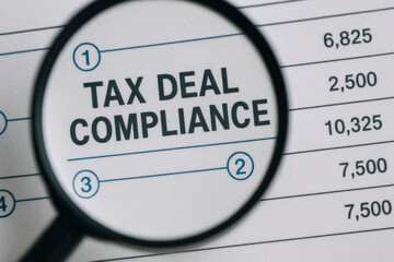 Tax deal compliance is essential for accurate financial records and smooth business operations under magnification on document with numbers