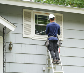 contractor working on replacing the window of the house