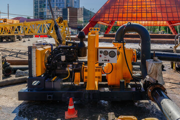 Cleaning sewer manholes by specialized pump machine on the street