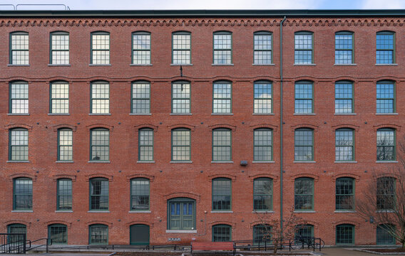 facade view of old factory building with red brick wall