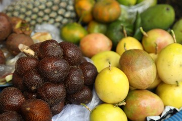Different fresh exotic fruits at market, closeup