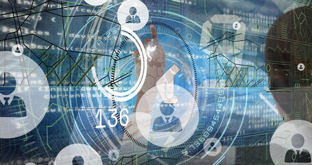 Tapping human hand engaging circular UI control in workspace, with avatar icons and data overlays