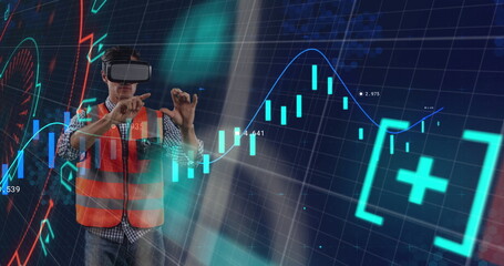 Male technician in safety vest and VR headset interacting in VR lab, holographic financial charts