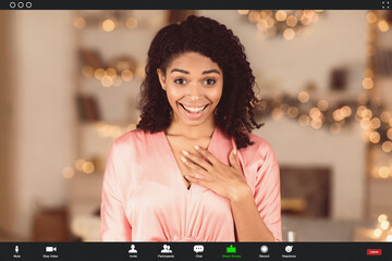 Virtual Meeting, Social Distancing, Isolation. Surprised happy black woman making online call on laptop, holding hand on chest, talking with partner, monitor view with app software for videotelephony