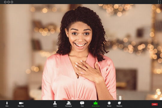 Virtual Meeting, Social Distancing, Isolation. Surprised happy black woman making online call on laptop, holding hand on chest, talking with partner, monitor view with app software for videotelephony