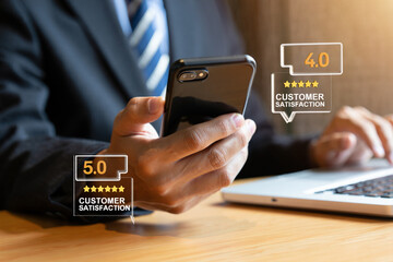 Businessman Checking Customer Satisfaction Ratings on Smartphone and Laptop