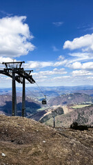 Vertical photo of mountain view with towers of cable car bringing tourist for hiking and skying and snowboarding in winter on Chleb over Vratna dolina in Mala Fatra in Slovakia.