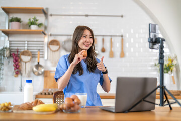 Asian woman nutritionist healthy food content creator live streaming with breakfast, milk, banana,...