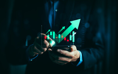 Businessman analyzing bullish stock market trend on smartphone with rising candlestick chart and...