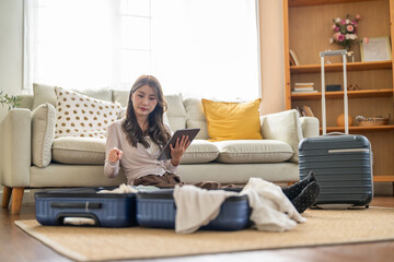 Obraz premium Portrait of woman use technology of tablet computer for hotel and resort booking online summer holiday travel system planning searching information weekend vacation trip.reservation online travel