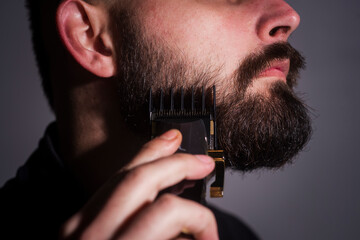 Barber background. Shaving beard. Barber making beard for bearded man at barbershop. Hairstyle,...