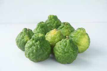Whole kaffir lime fruit or bergamot arranged on a white background that is isolated