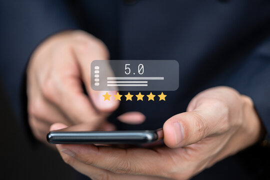 Person using smartphone to give a five star rating online review - Powered by Adobe