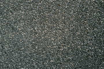 Small road stone background, dark gravel pebbles. Stone texture seamless texture. Stone road. Stone road background.
