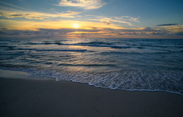 Sunrise on the sea with clouds background. Seascape at evening. Ocean waves background.