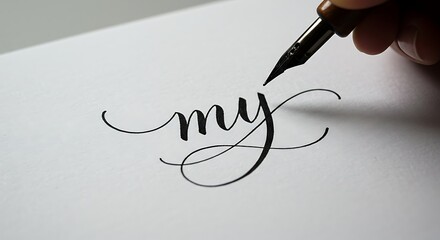Fototapeta premium Writing with Calligraphy Pen on Paper - Artistic Lettering