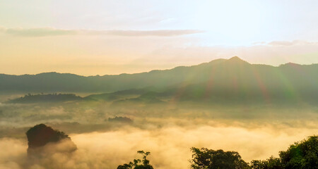 Dramatic sunset over mountain landscape. Beautiful landscape foggy hills twilight time. Blue golden sky sunrise dramatic beautiful landscape mountain. Dawn sky gold dusk time cloudscape with sunlight