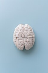concept of brain storming critical thinking mental health, puzzle pieces arranged in the shape of human brain against a plain blue background with negative space for text 