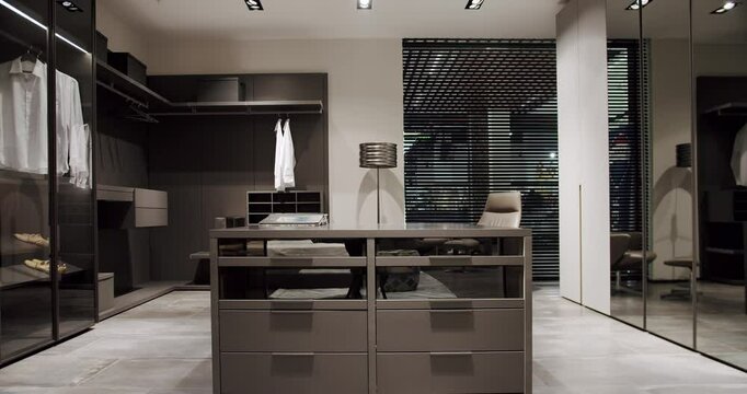 Dressing room with shirts. Elegant Wooden Built Walk In Closet Decoration. Luxury Dressing Room. Modern Sliding Doors. Black wardrobe with Sliding Black Doors. Luxury Bedroom With Walk In Closet.