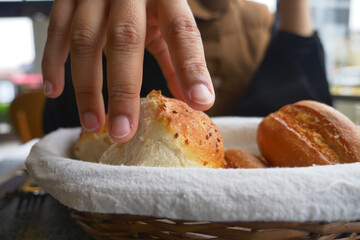 Fresh bread rolls served in a basket at a cafe