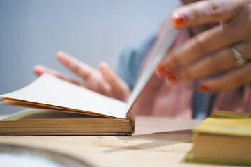 Browsing pages of a book in a cozy reading space
