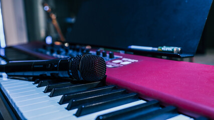 Microphone on midi piano keyboard keys. Recording studio concept