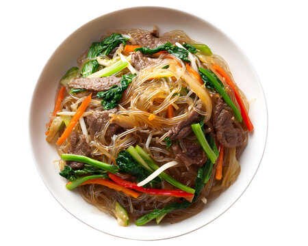 Korean japchae sweet potato noodles stir fried with beef and vegetables in white bowl isolated on transparent background