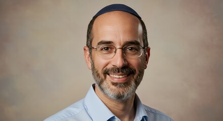 Portrait of a Smiling Man Wearing a Kippah and Glasses