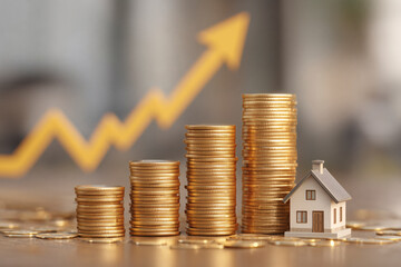 Home investment: Rising coin stacks symbolize property value growth with upward trending chart backdrop.