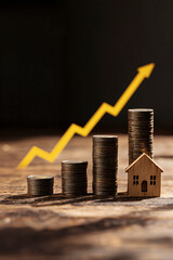 Real estate investment growth shown with coin stacks, housing model, and upward arrow.
