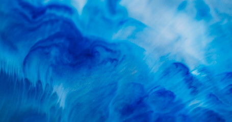 Paint flow. Dye fluid. Blue enamel art blend white acrylic stream. Color mix emulsion texture abstract emulsion defocused background.