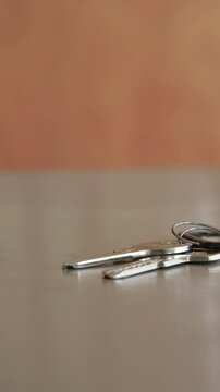 Keys resting on a wooden table in an indoor setting
