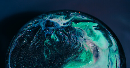 Wet shimmering. Acrylic spill. Black green sparkling paint mixing abstract color circle. Pigment...