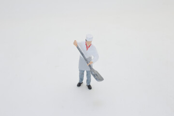 Miniature Figure of a Chef Holding a Large Silver Spoon