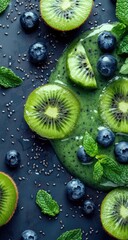 Fresh kiwi and blueberry smoothie, garnished with mint and chia seeds, on a dark background