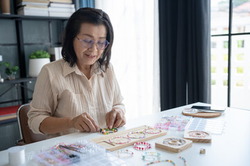 Senior mature older asian woman Art hobby handmade making beads jewellery accessories handcraft...