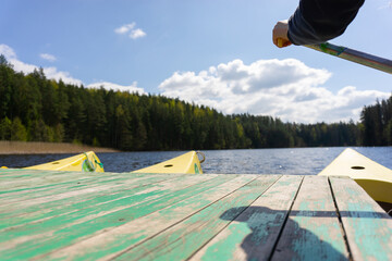 Canoeing adventure on a calm forest lake in Estonia with sunlight and scenic nature