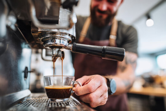 Happy barista preparing coffee at a café