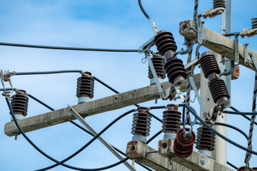 High voltage transmission pole with electrical equipment including cables and insulators on...